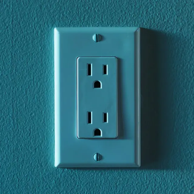 A duplex outlet on a painted wall