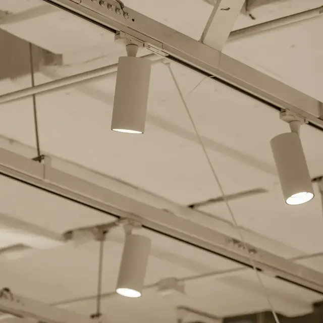 Track lights on an open commercial ceiling